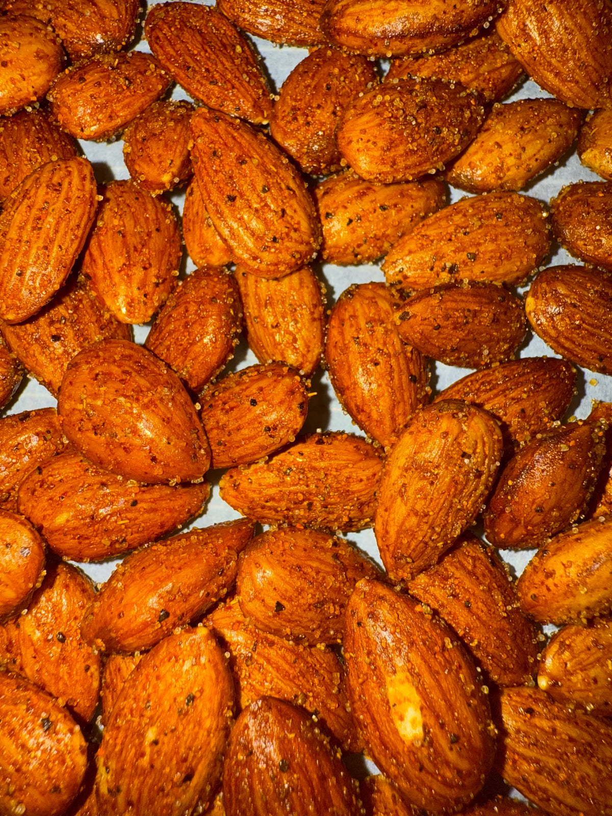 Pile of spicy garlic roasted almonds, small-batch roasted in Idaho