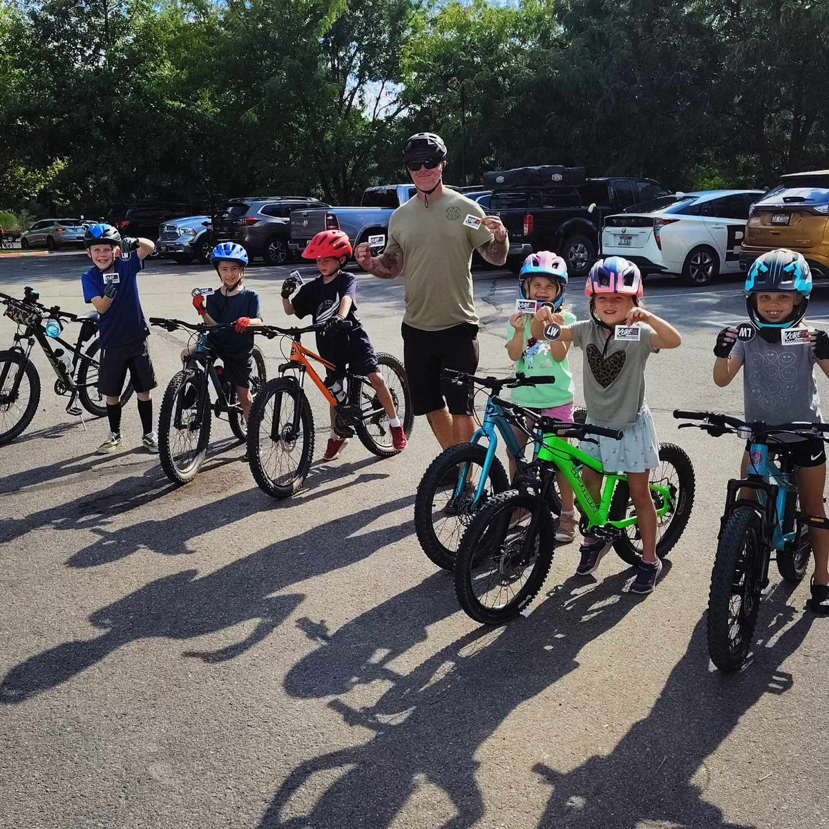 Coach with a group of kids and their bikes