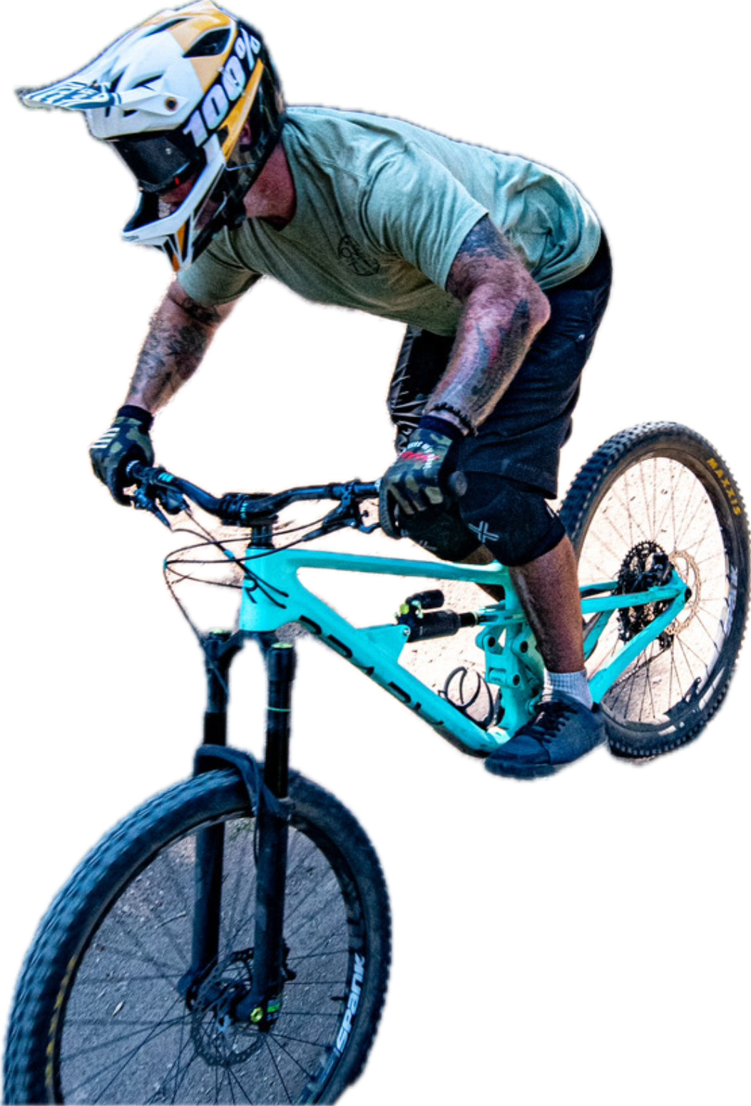 Mountain biker in a full-face helmet riding a teal bike
