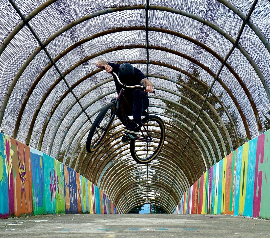 Rider in the air in a colourful tunnel